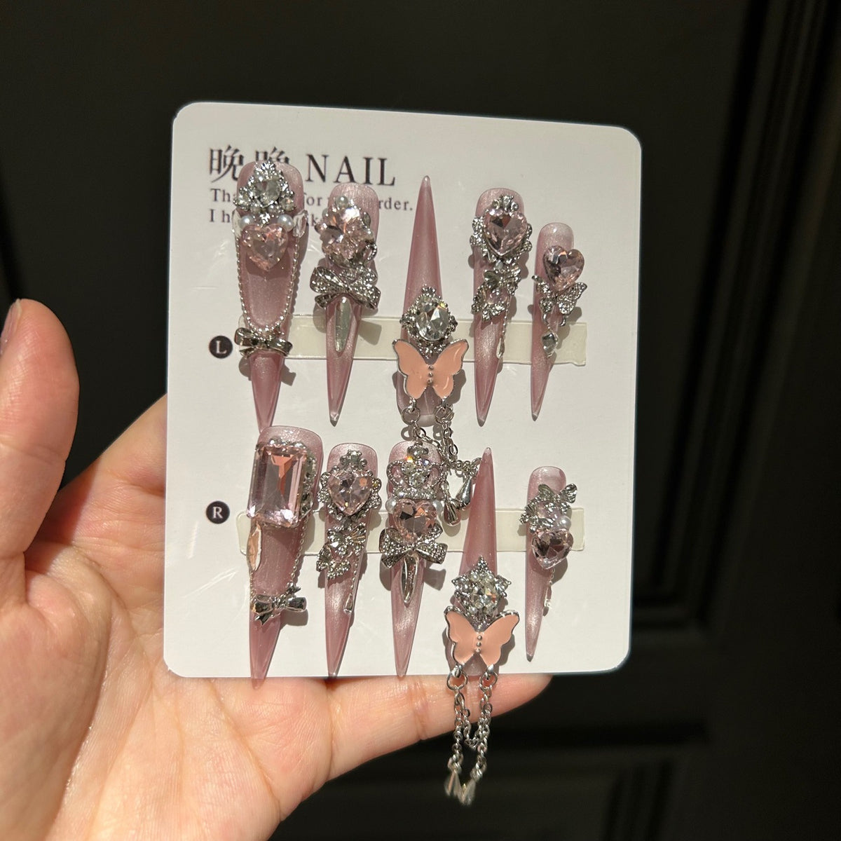Handmade Soft Nude Pink Press On Nails, Long Stiletto Princess False Nails with Pink Heart Rhinestones, 3D Butterfly, Silver Bow Charms, Pearls & Dangling Silver Chain, Reusable Fake Nails for Wedding & Party