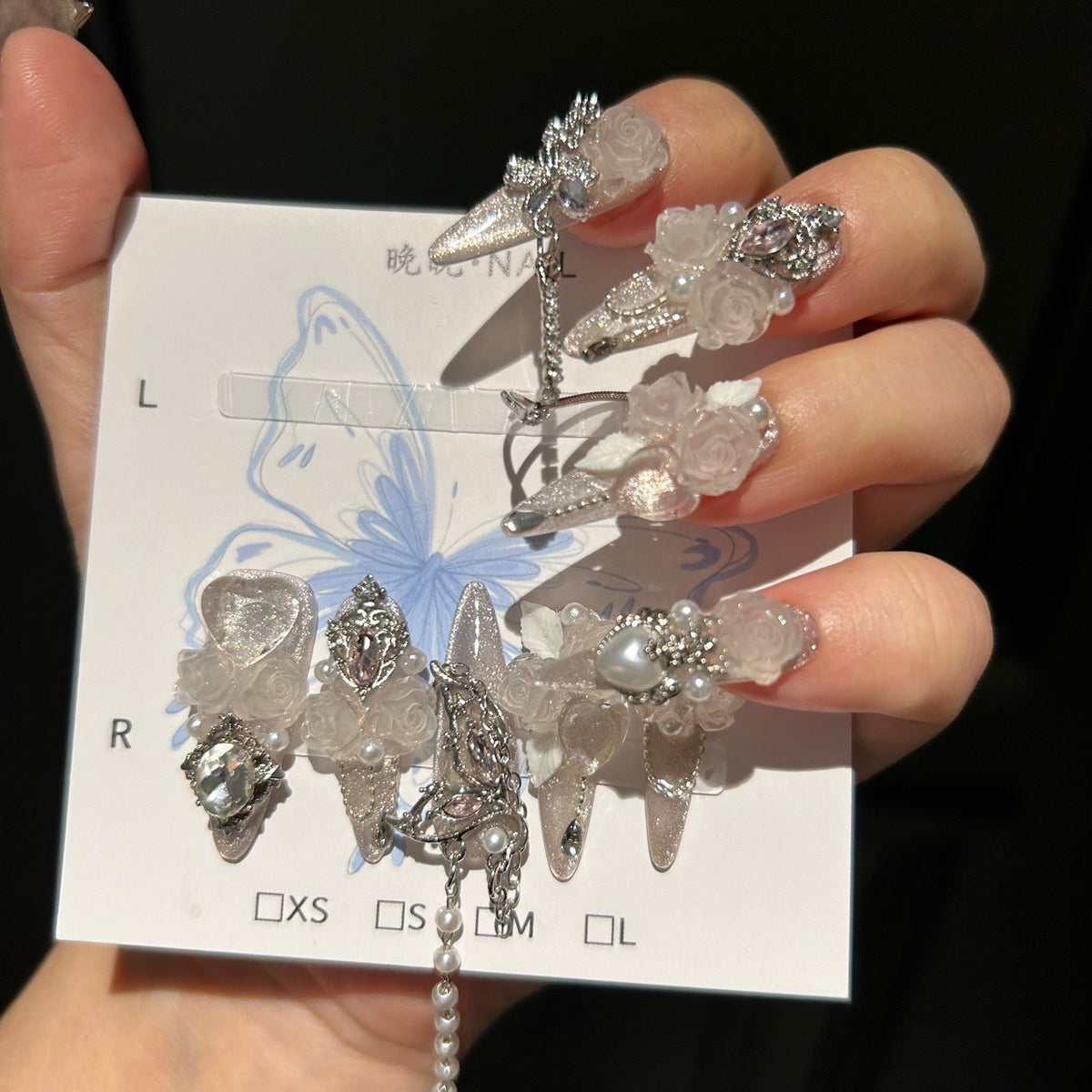 Handmade Milky Silver Cat Eye Long Stiletto Press On Nails with Frosted 3D White Roses, Butterfly Charms, Heart Crystals & Pearl Chain Tassels