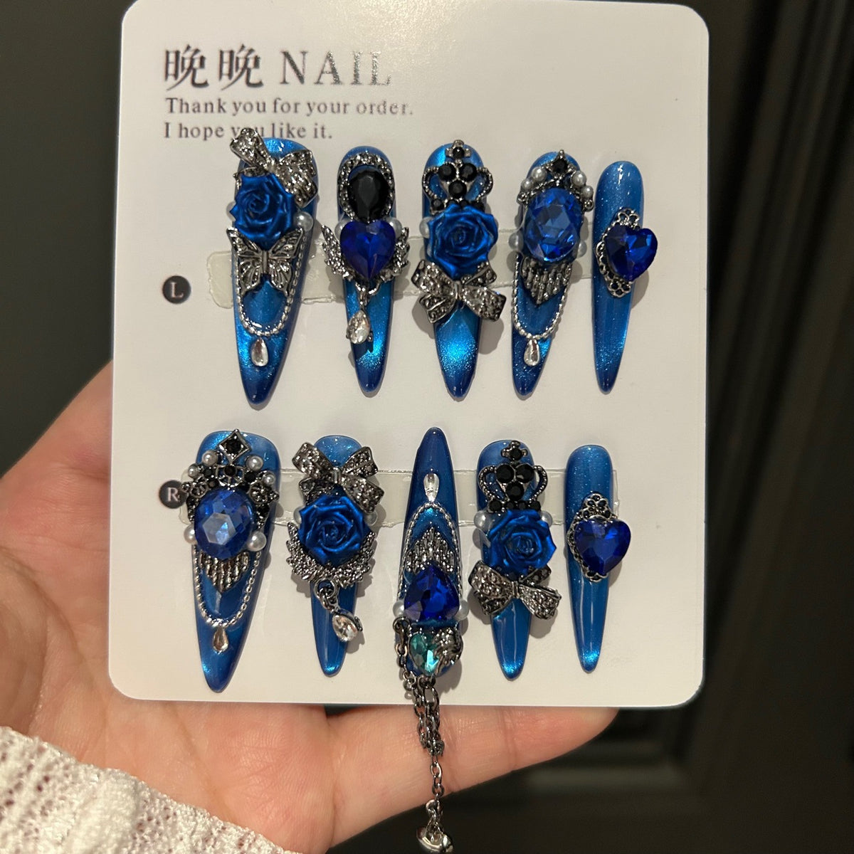 Handmade Electric Blue Cat Eye Long Stiletto Press On Nails with 3D Blue Roses, Giant Blue Heart Crystals, Rhinestone Crowns, Butterfly Charms & Dangling Chains