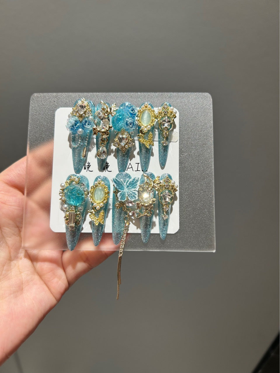 Handmade Sparkly Turquoise Glitter Long Stiletto Press On Nails with 3D Blue Roses, Gold Butterfly Charms, Oval Gemstones & Gold Chain Tassels