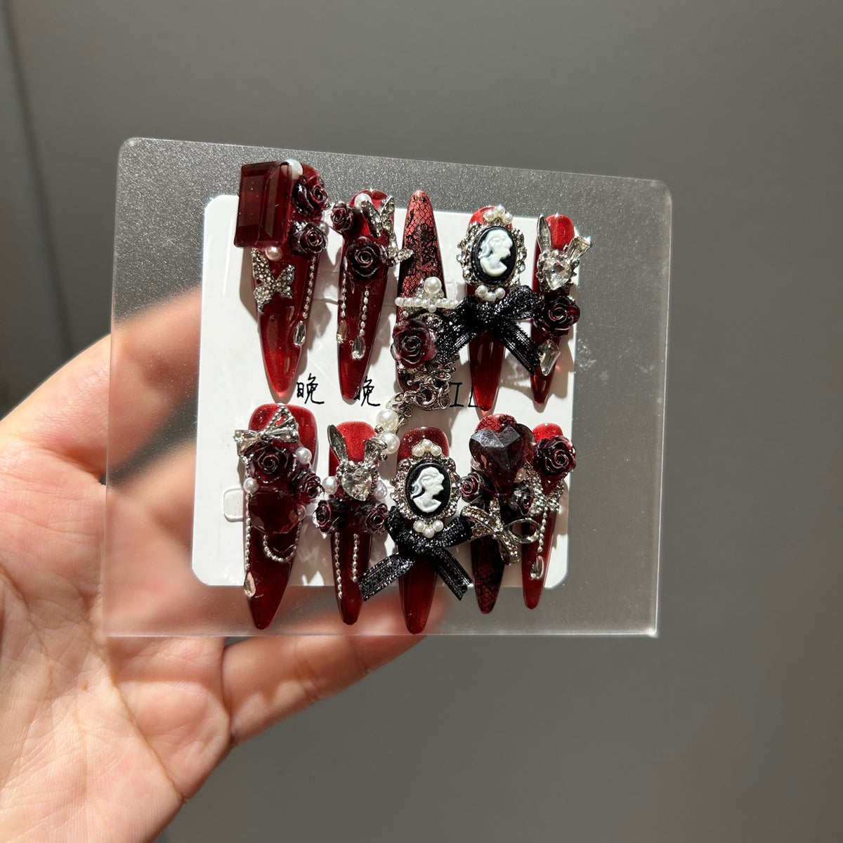 Handmade Metallic Red Long Stiletto Press On Nails with Vintage Cameo Portrait, 3D Dark Red Roses, Black Bows, Crystals & Pearl Chain Tassels