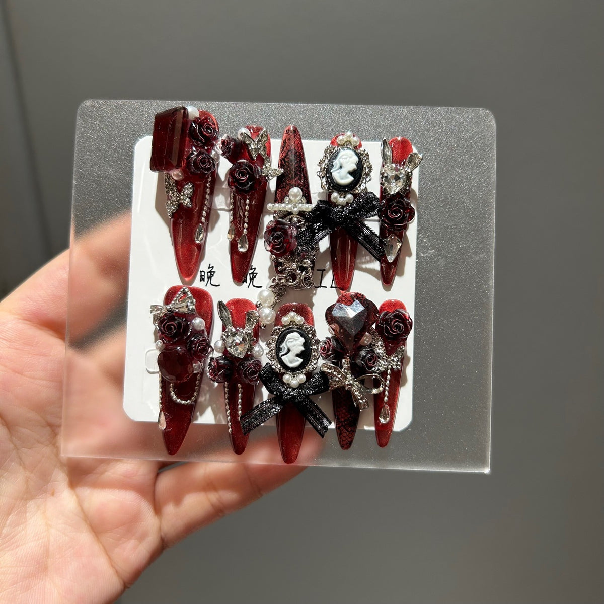 Handmade Metallic Red Long Stiletto Press On Nails with Vintage Cameo Portrait, 3D Dark Red Roses, Black Bows, Crystals & Pearl Chain Tassels