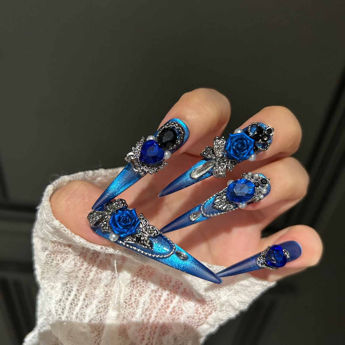 Handmade Electric Blue Cat Eye Long Stiletto Press On Nails with 3D Blue Roses, Giant Blue Heart Crystals, Rhinestone Crowns, Butterfly Charms & Dangling Chains