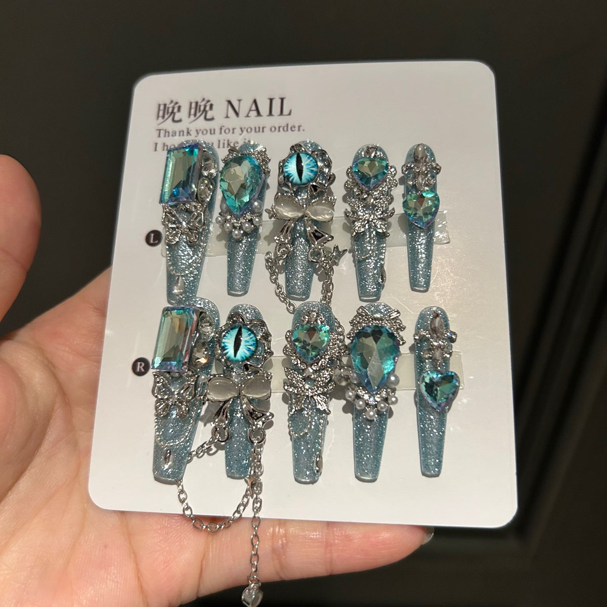 Icy Blue Cat Eye Coffin Press-on Nails with Oversized Iridescent Crystals, 3D Evil Eye, Bow, and Interlinked Chain - Y2K Cyber Glam Fake Nail Set